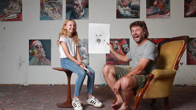 Artist Ben Quilty and his daughter Liv in Quilty's Mittagong studio doing Liv's surprised face. Quilty presented an online tutorial about how to draw a portrait as part of the Art Gallery of NSW's digital season. Picture: John Feder/The Australian.