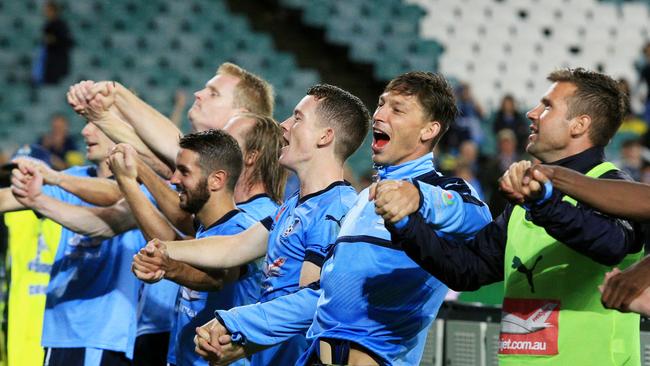 Sydney FC celebrate their win infront of the Cove.