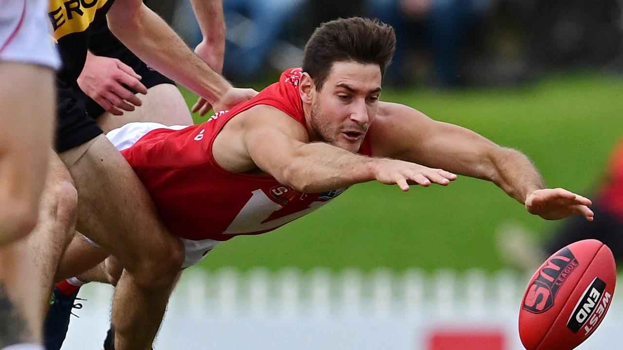 11/06/18 - SANFL match between Glenelg and North Adelaide at Glenelg Oval.  North's Aidan Tropiano dives for the ball. Picture: Tom Huntley