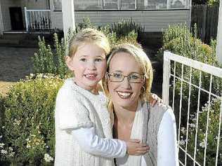 Emily Barnes cuddles up with daughter Olivia at their new family home quickly snapped up before the State Government cuts its stamp duty concession on Monday. Picture: Nev Madsen