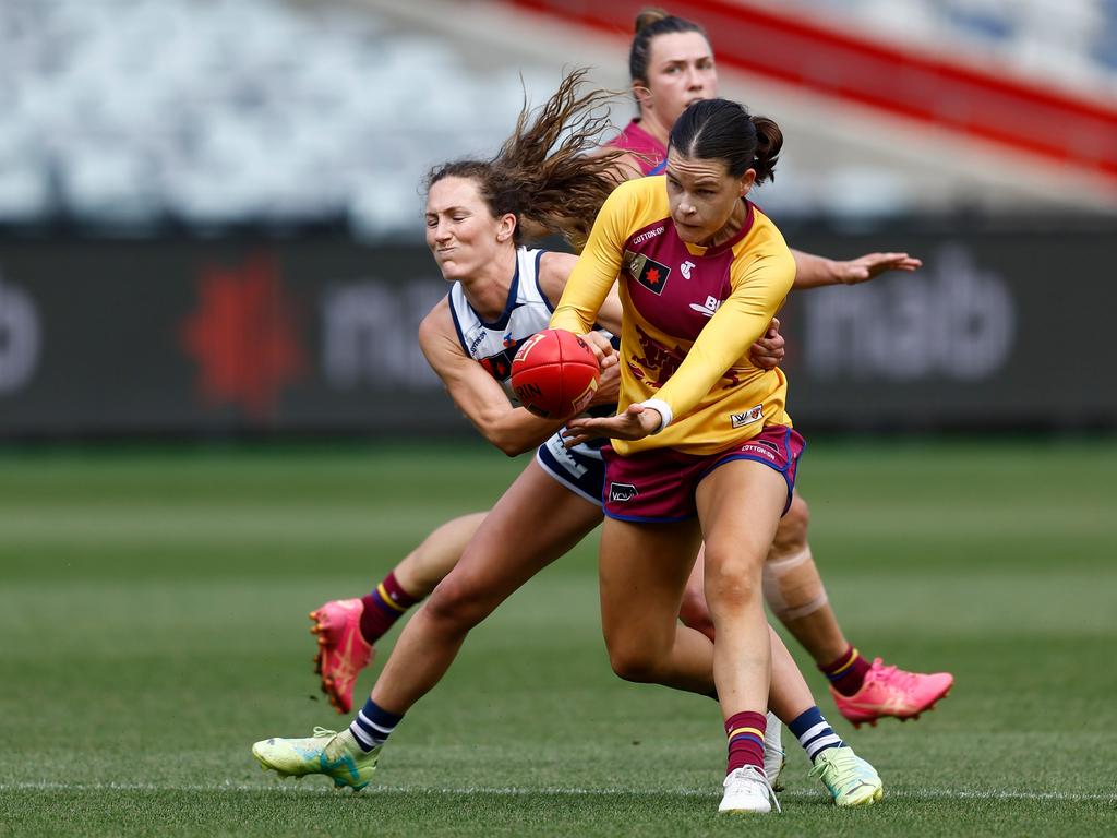 Sophie Conway of the Lions is tackled by Georgie Rankin. Picture: Michael Willson/AFL Photos via Getty Images.