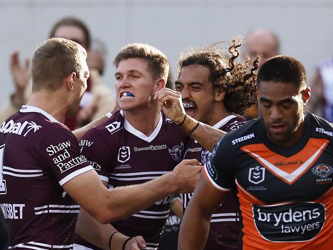 SYDNEY, AUSTRALIA - MAY 07: Reuben Garrick of the Sea Eagles celebrates a try with team mates during the round nine NRL match between the Manly Sea Eagles and the Wests Tigers at 4 Pines Park, on May 07, 2022, in Sydney, Australia. (Photo by Mark Evans/Getty Images)