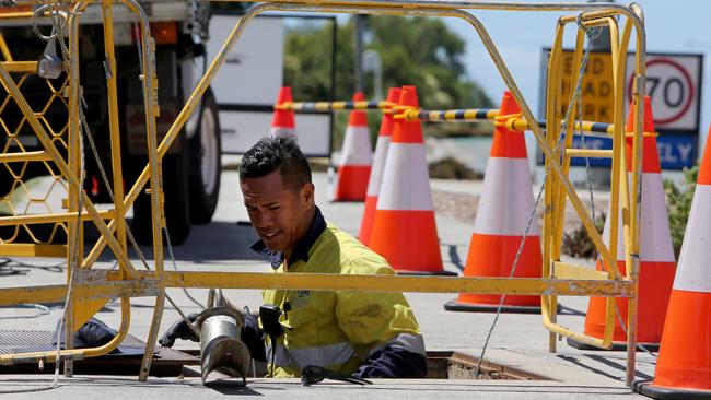 Workers laying fibre NBN cable. The NBN now reaches more than 5 million Australian premises. Picture: Chris Higgins