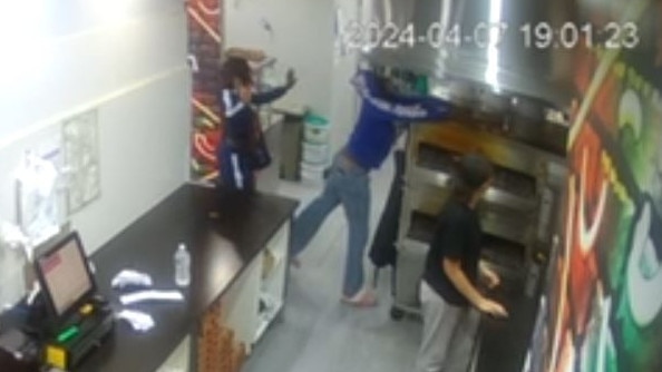 Staff were powerless to stop the pair from walking past the counter and grabbing the food. <br/> Picture: Supplied