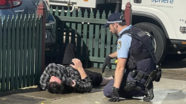 Reed was seen laying on the floor while police officers spoke to him. Picture: The Daily Telegraph