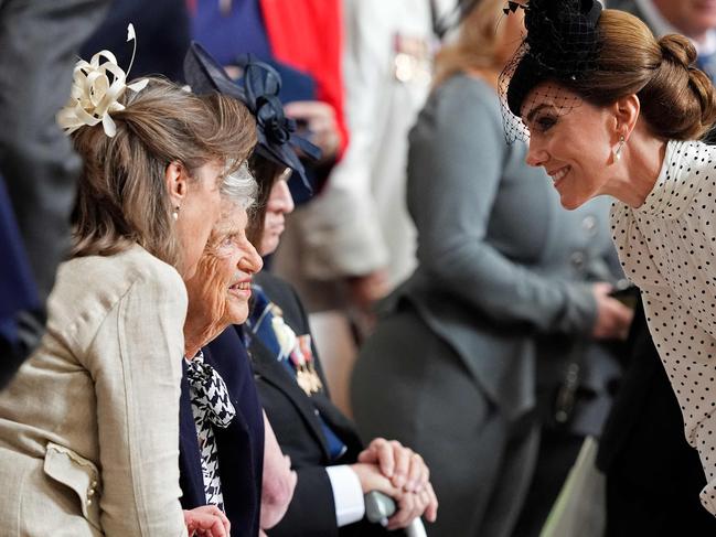 Britain's Catherine, Princess of Wales speaks to a veteran as they leave the service. Picture: AFP