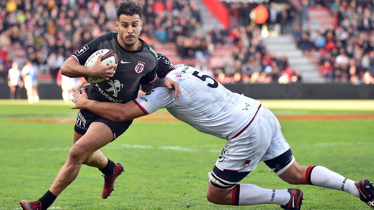 Toulouse’s Sofiane Guitoune is tackled around the waist at Ernest Wallon Stadium.
