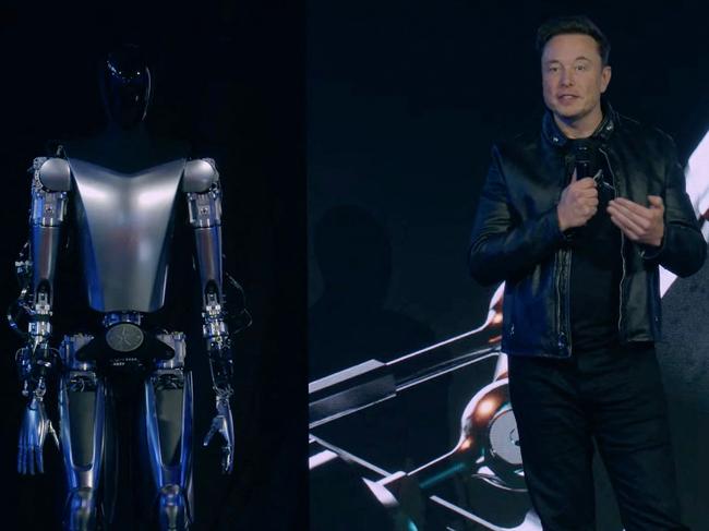 This video screen grab made from Tesla AI Day 2022 livestream shows Elon Musk standing on stage next to Optimus the humanoid robot in Palo Alto, California on September 30, 2022. (Photo by Tesla / AFP) / RESTRICTED TO EDITORIAL USE - MANDATORY CREDIT "AFP PHOTO / HANDOUT / TESLA " - NO MARKETING - NO ADVERTISING CAMPAIGNS - DISTRIBUTED AS A SERVICE TO CLIENTS