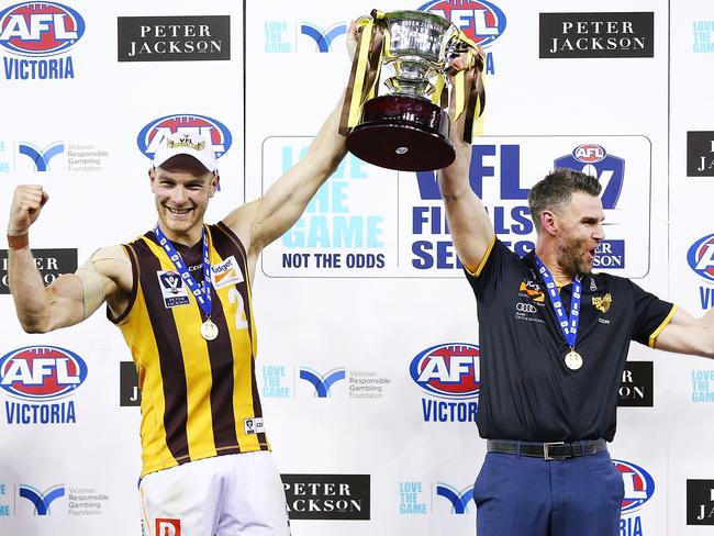 Andrew Moore hoists the VFL premiership cup with coach Chris Newman. Picture: Michael Dodge/AFL Media/Getty Images