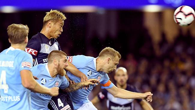 Keisuke Honda rises above the Melbourne City defence to head home for Victory at Marvel Stadium on Saturday night. Picture: AFP