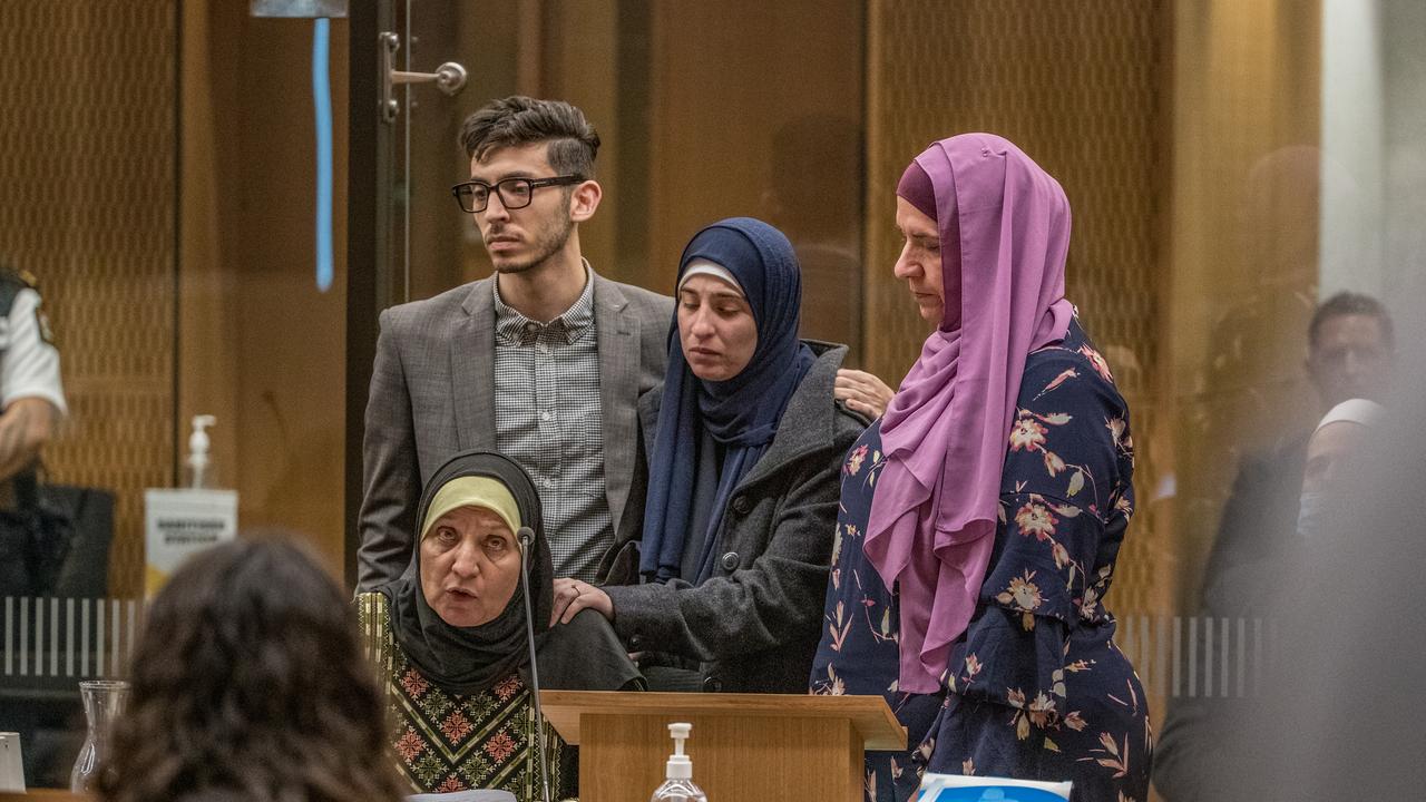 Survivors comfort each other during the hearing.