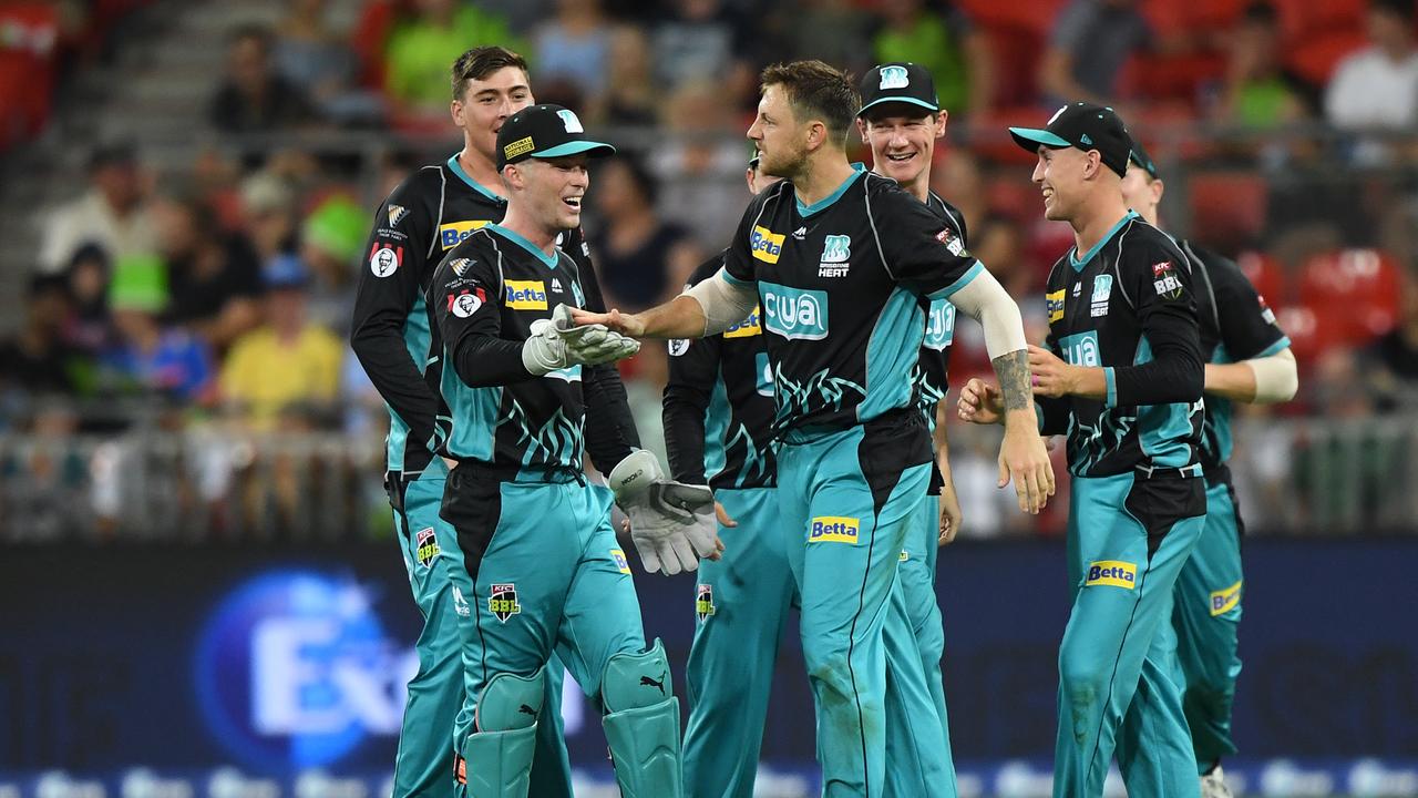 James Pattinson of the Brisbane Heat celebrates with teammates after taking a wicket last season