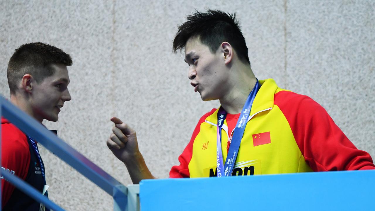 Sun Yang (R) remonstrates with Duncan Scott during the medal ceremony.