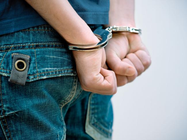 Generic Thinkstock image of youth crime - hand cuffs teenager under arrest.