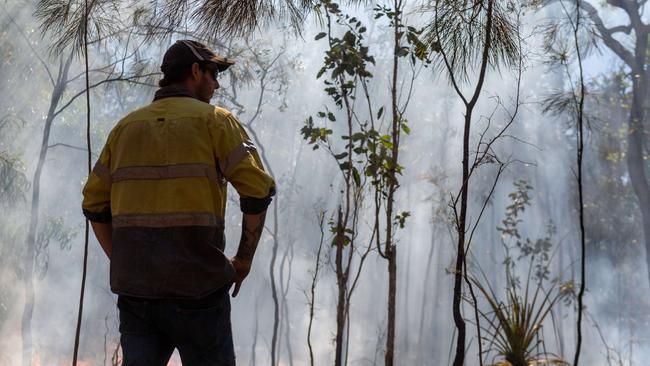 Grant Hopkins had his house surrounded by a bushfire on Monday near Noonamah. Local volunteer firefighters saved his house from damage, but his property was engulfed in flames. Picture: Che Chorley