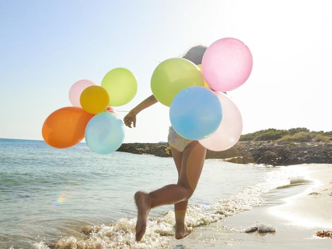 Girl on the beach with balloons
