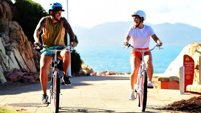 Dan Southwell and Heidi Joosten with their beach cruisers on the Strand. Picture: Alix Sweeney