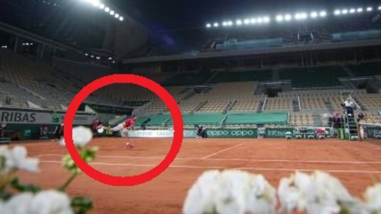 Roger Federer in an empty Roland Garros stadium.