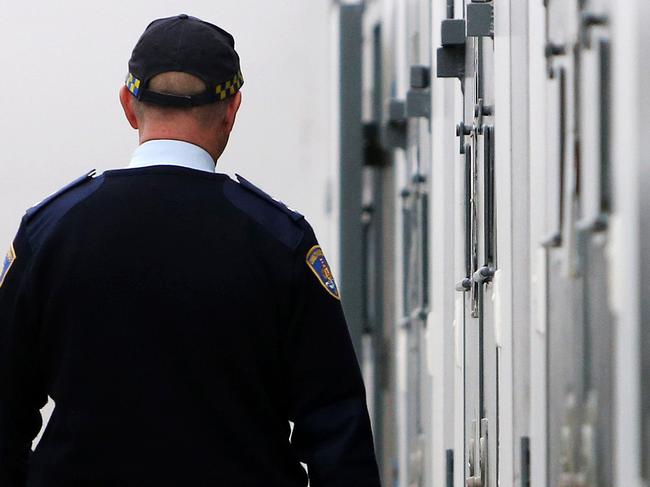 WARNING SUNDAY TELEGRAPH ONLY - SPEAK TO JEFF DARMANIN - Pictured is a Correctional Services Officer walking down one of the cell blocks at Silverwater Correction Centre. Picture: Tim Hunter.