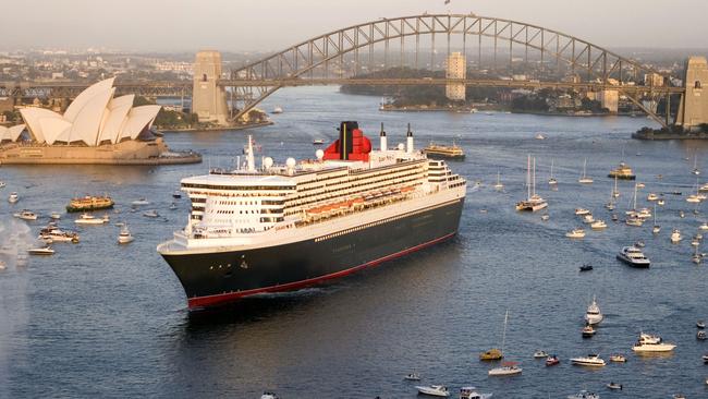 Queen Mary 2, surrounded by a flotilla of small craft, arriving in Sydney Harbour at sunrise in 2007. We will get another visit from a Queen this year.