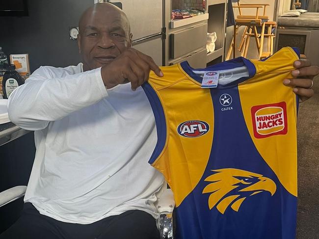 Mike Tyson holding a West Coast Eagles jumper