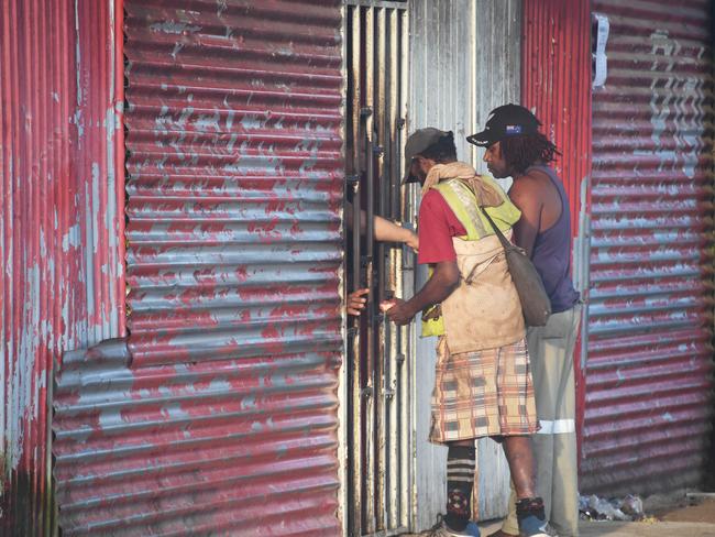 Manus locals do their shopping through an iron gate. Picture: Brian Cassey