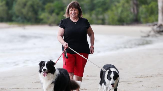 Cairns resident Judy Edwards walks her rescue border collies Jarvis and Vinnie on Kewarra Beach. Picture: Brendan Radke