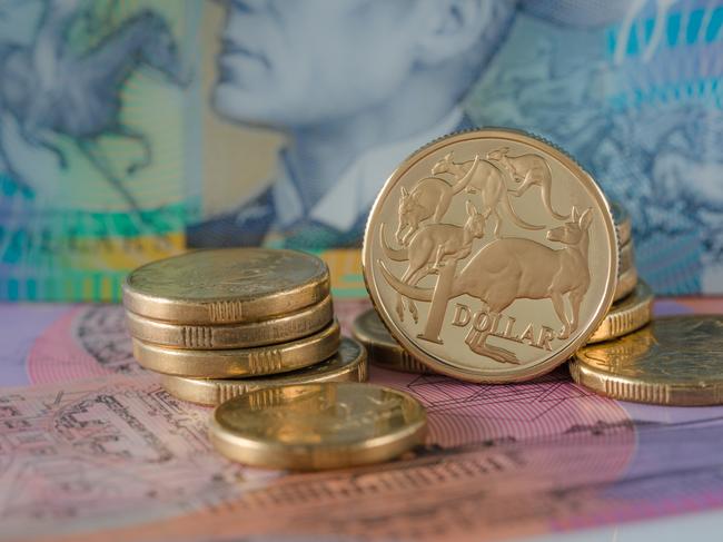 One and Two Dollar Coins Australian ten and five dollar notes in the background - Australian Currency; savings money notes generic