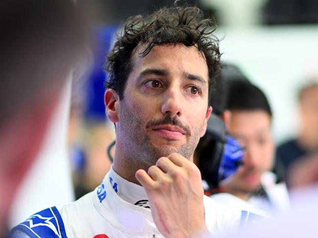 BAHRAIN, BAHRAIN - FEBRUARY 21: Daniel Ricciardo of Australia and Visa Cash App RB talks with Visa Cash App RB team members in the garage during day one of F1 Testing at Bahrain International Circuit on February 21, 2024 in Bahrain, Bahrain. (Photo by Rudy Carezzevoli/Getty Images)