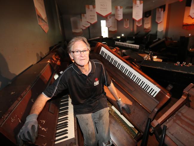 Store manager Garry Smith surveys the damage at Australian Piano Warehouse in Brisbane’s Milton. Picture: Annette Dew