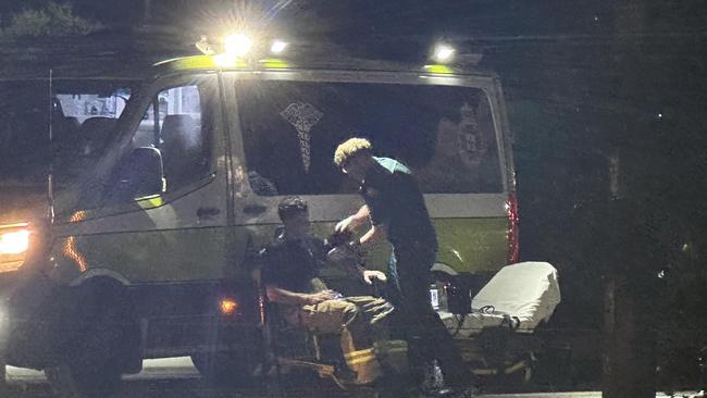 A firefighter being treated by paramedics at the scene of a large industrial fire in Portsmith. Picture: Sam Davis