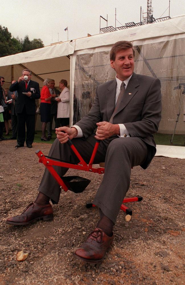 Former premier Jeff Kennett uses a miniature digger to lift some soil for the new apartments to be built at Eastern Beach, Geelong in February 1999.