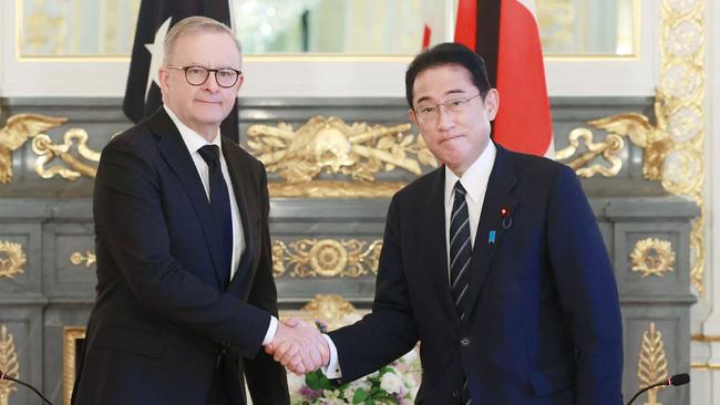 Anthony Albanese shakes hands with Japan's Prime Minister Fumio Kishida.