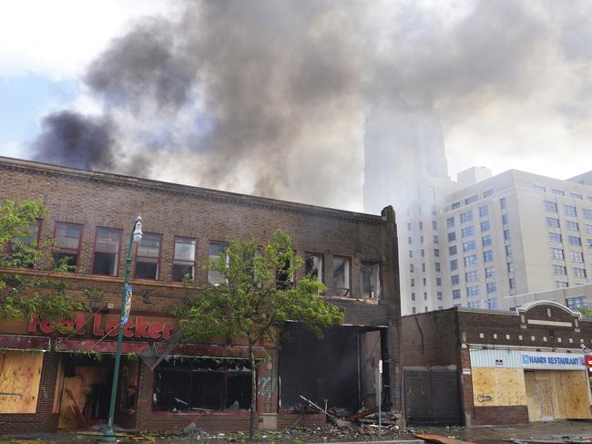 The Foot Locker Store and the apartments above it burn along Lake Street in Minneapolis. Picture: AP