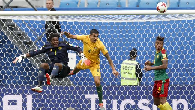 From left, Tim Cahill challenges Cameroon goalkeeper Fabrice Ondoa during the Confederations Cup, Group B soccer match between Cameroon and Australia.