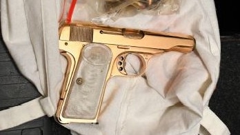 A golden gun and bullets seized by Australian Federal Police in the raid.