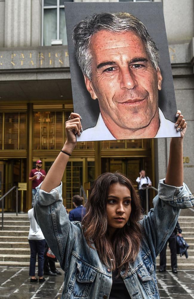 A protest group called "Hot Mess" hold up photos of Jeffrey Epstein in front of the Federal courthouse on July 8, 2019 in New York City. Picture: AFP.