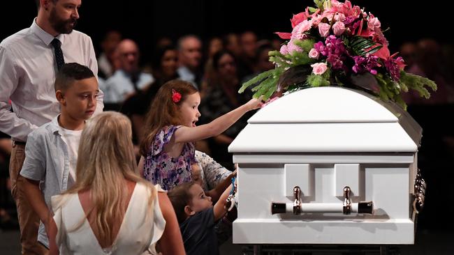 Children place butterfly stickers on the coffin. (AAP Image/Dan Peled)