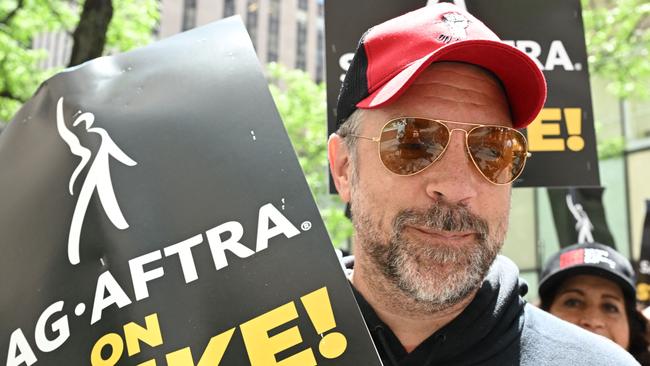 US actor Jason Sudeikis joins members of the Writers Guild of America and the Screen Actors Guild as they walk a picket line outside NBC Universal in New York City on July 14, 2023. Tens of thousands of Hollywood actors went on strike at midnight July 13, 2023, effectively bringing the giant movie and television business to a halt as they join writers in the first industry-wide walkout for 63 years. (Photo by TIMOTHY A. CLARY / AFP)