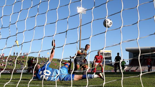 Denis Genreau of Macarthur FC scores his team’s goal past Oliver Sail of the Phoenix at WIN Stadium in Wollongong. Picture: Getty Images