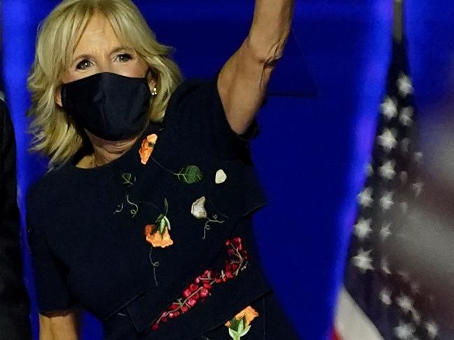 TOPSHOT - US President-elect Joe Biden with his wife Jill Biden salute the crowd on stage after delivering remarks in Wilmington, Delaware, on November 7, 2020, and being declared the winner of the US presidential election. (Photo by Andrew Harnik / POOL / AFP)