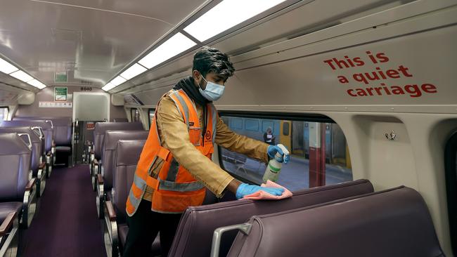 Cleaners wipe down surfaces after Sydney public transport routes were listed as exposure sites. Picture: NCA NewsWire / Dylan Coker