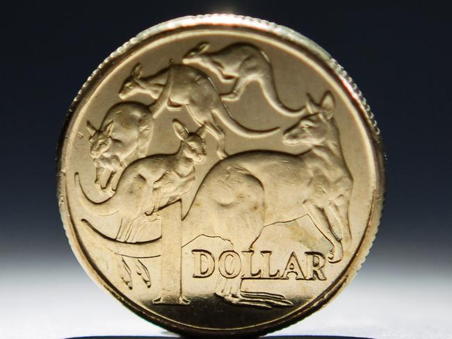 An Australian one-dollar coin is arranged for a photograph in Sydney, Australia, on Wednesday, April 17, 2013. Direct trading between the Australian dollar and yuan started on April 10. Photographer: Ian Waldie/Bloomberg