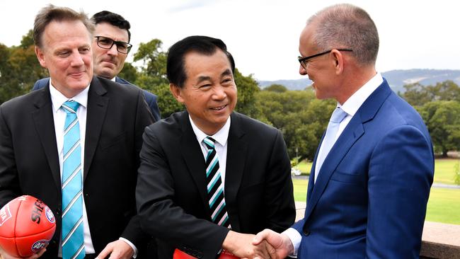 Port Adelaide’s Shanghai backer, billionaire Guo Jie Gui, shakes hands with SA Premier Jay Weatherill, right, on confirmation of the Power returning to China for a second AFL premiership match in May. Gui wants more and more AFL in China. Picture: Morgan Sette (AAP)