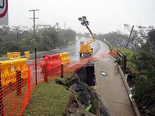 The footpath and some of the road have fallen down on David Low Way at Sunrise Beach. The road was still open at 3.30pm yesterday but closed by Noosa Council. Photo: Cade Mooney