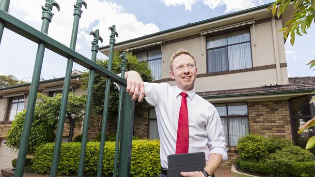 Richardson and Wrench Ingleburn real estate agent Josh Mayo at 13 Paterson Street which he sold for $955,000 after auction. Picture: AAP/Matthew Vasilescu