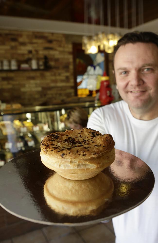 Baker Andrew Day at Gerbino’s Bakery in Ashgrove, with a chilli beef pie. Photo: Anthony Weate.