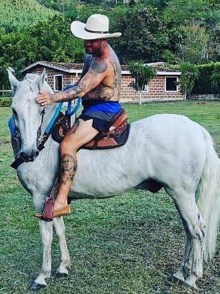 Meehan flaunts his tattoos on horseback.