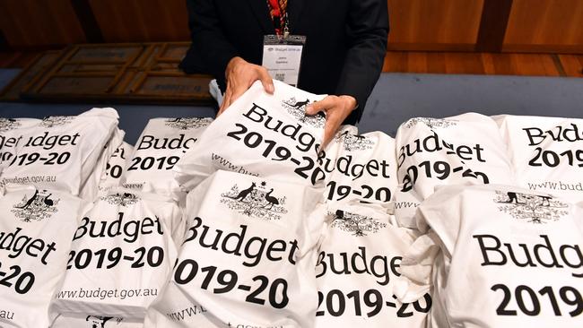 A Treasury official arranges the bags with the Budget papers during the lockup earlier on Tuesday at Parliament House in Canberra. Picture: AAP