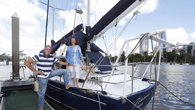 Phillip Smart and Suzanne Mimnaw next to their boat Tiamo, which appeared in the ABC crime show Harrow as Debbie, docked in Brisbane River near Kangaroo Point, Brisbane, June 10, 2018. (AAP Image/Regi Varghese)